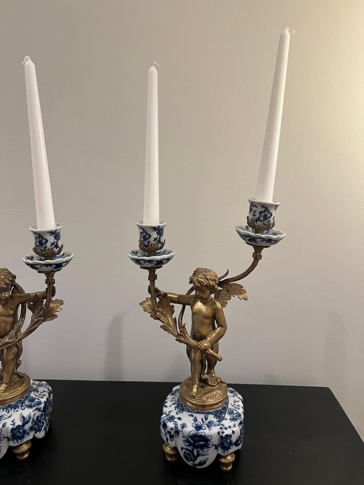 Ornate Cherub Candelabra Pair – Gilt Metal with Blue & White Porcelain Bases