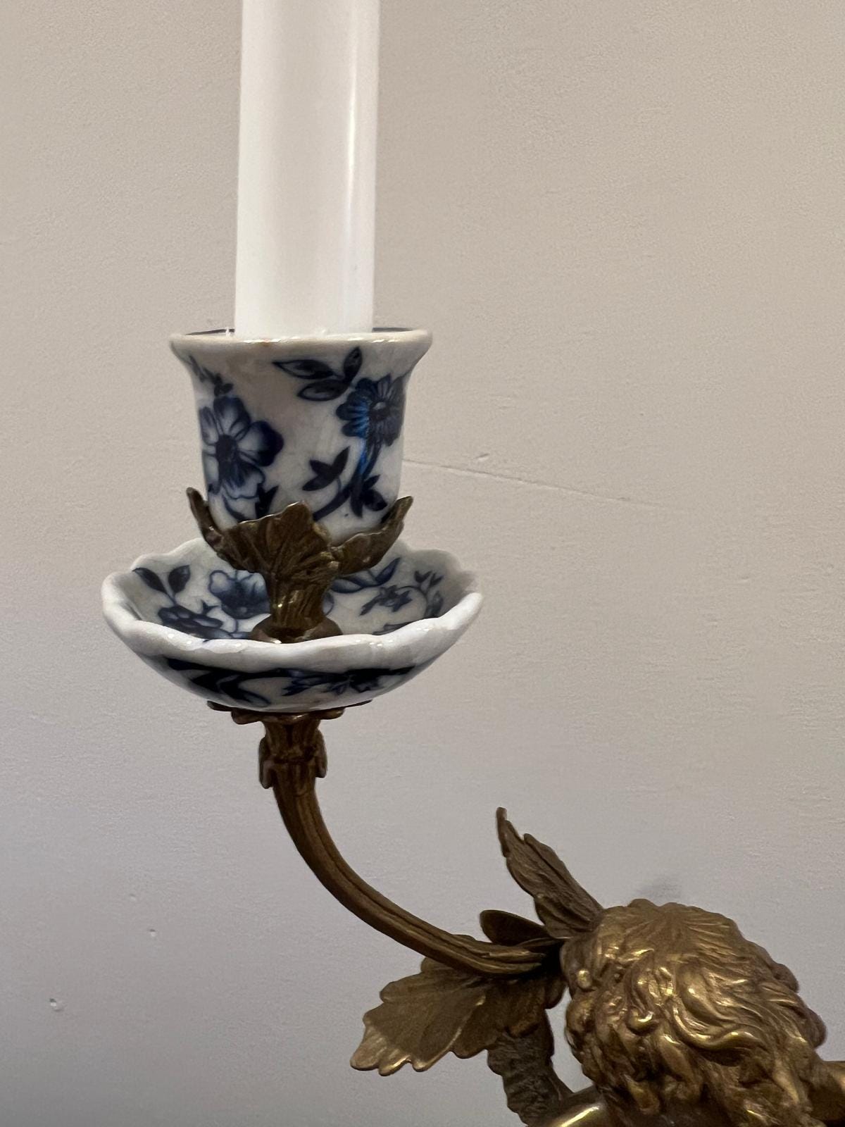 Ornate Cherub Candelabra Pair – Gilt Metal with Blue & White Porcelain Bases