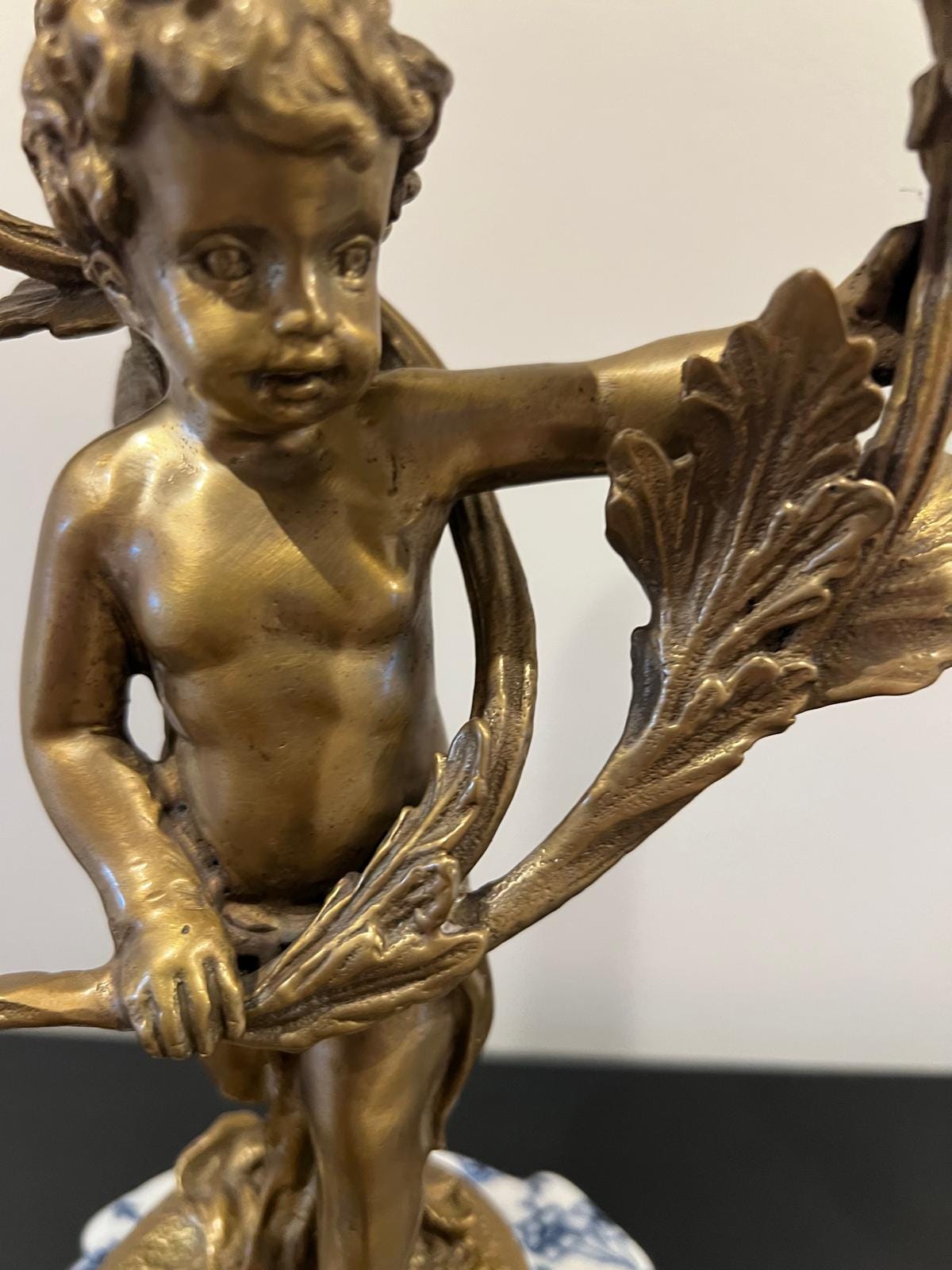 Ornate Cherub Candelabra Pair – Gilt Metal with Blue & White Porcelain Bases