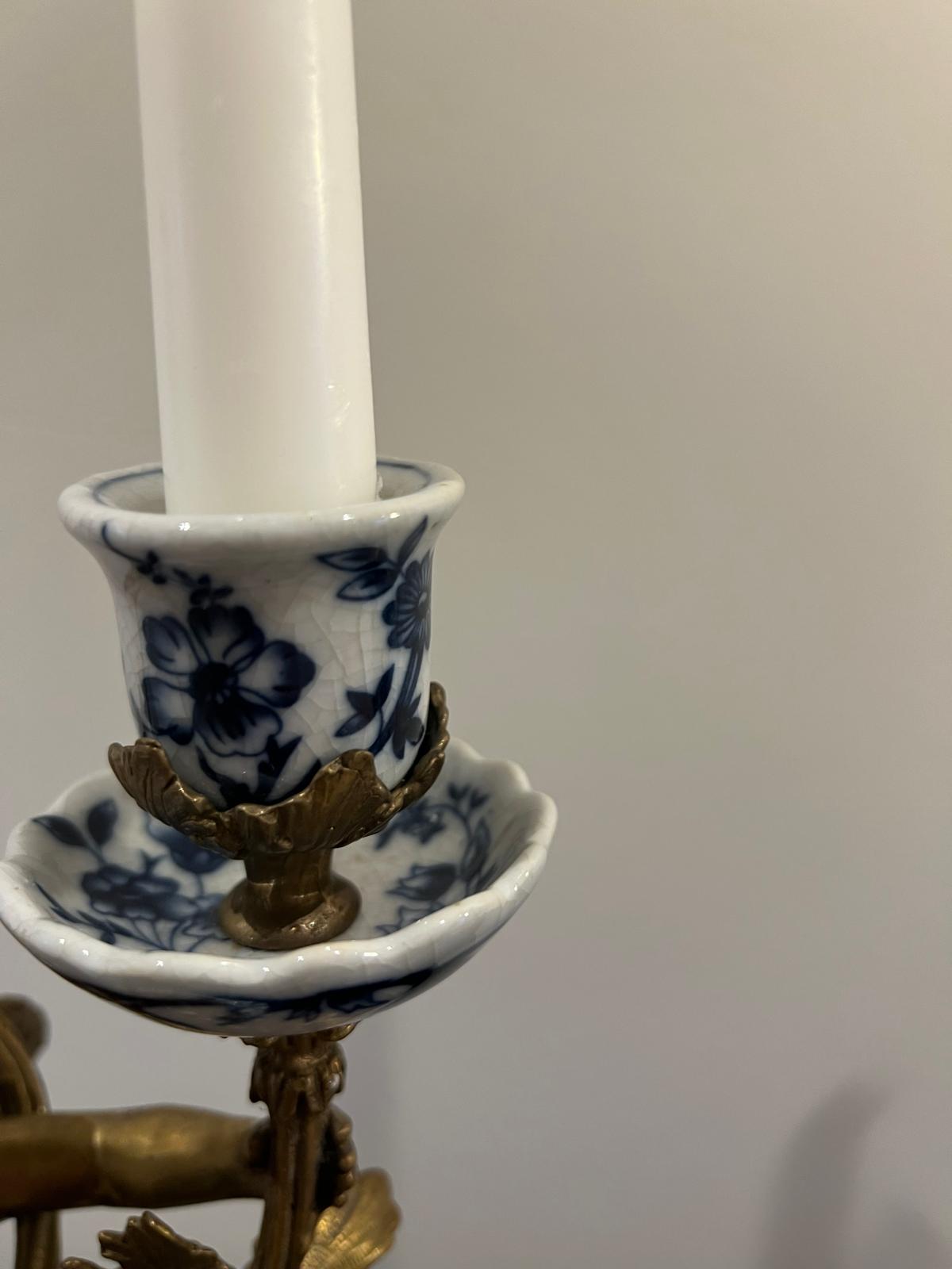 Ornate Cherub Candelabra Pair – Gilt Metal with Blue & White Porcelain Bases